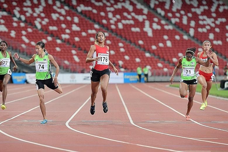 Shanti Pereira (centre) crossing the finish line in 23.87sec to win 200m gold at the Singapore Open Track and Field C'ships at the National Stadium. Her timing meets the SEA Games qualifying mark of 23.92sec.
