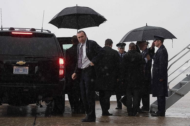 Secret Service agents surrounding Mr Donald Trump at Andrews Air Force Base in Maryland this month.