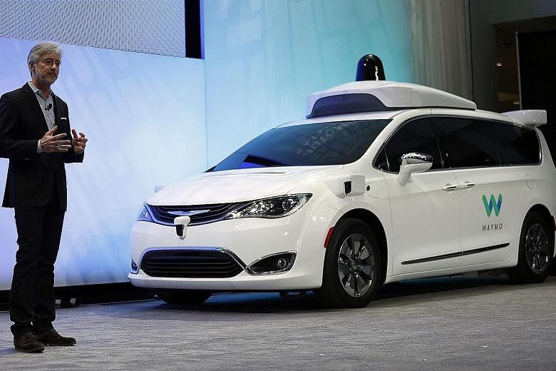 Alphabet Inc's self-driving car unit Waymo's chief executive officer John Krafcik with a customised Chrysler Pacifica Hybrid. Initial users will be able to book the minivans with an app for free.