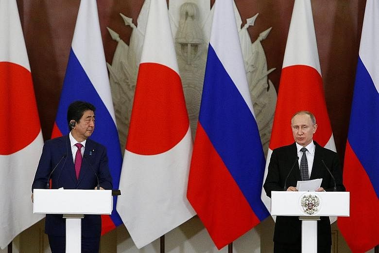 Japanese Prime Minister Shinzo Abe and Russian President Vladimir Putin at a media briefing following their meeting at the Kremlin in Moscow on Thursday. The two also spoke about rising tensions over North Korea.