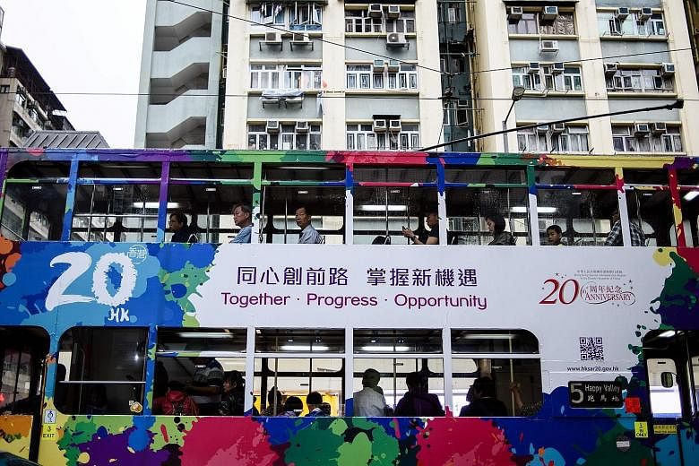 A tram in Hong Kong adorned with artwork commemorating the 20th anniversary of the city's handover to China by Britain. Chinese President Xi Jinping is expected to visit the city for the July 1 anniversary, his first trip there since coming to power 