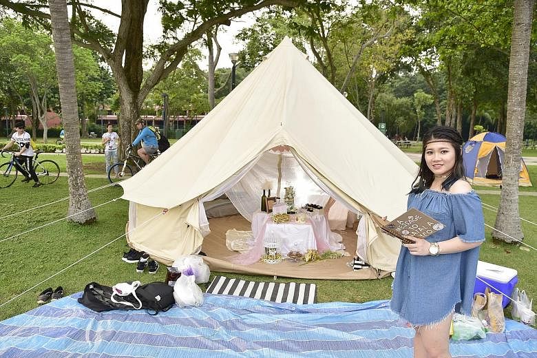 Customers of glamping service provider Noor Azmi Omar (not pictured), who charges $230 a night for a tent that can fit 12 people, giving their glamping package the thumbs up. Six-year-old Goh Jun Yi (second from right) and his mother Lim Fang Qi (beh