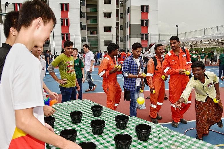 Mr Muthukaruppan Muneeswaran (far right), a 20-year-old process maintenance and construction worker from India, was among 5,000 migrant workers who played games and feasted on local delights at an event organised at the Westlite Papan dormitory in Ja