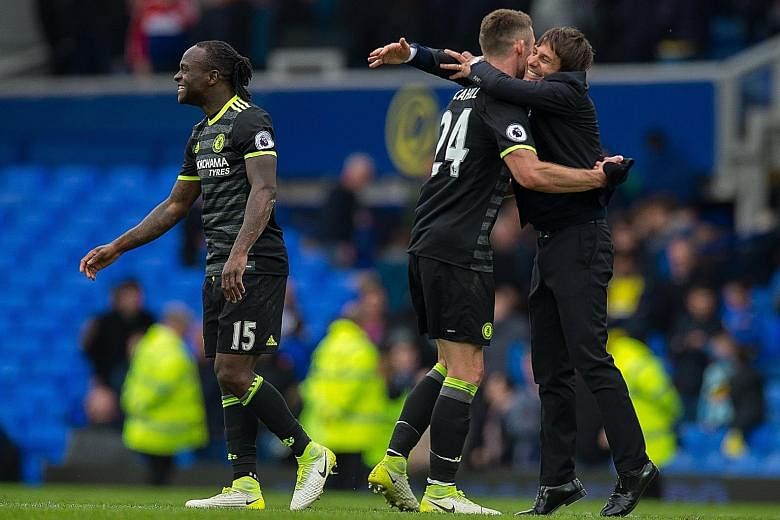 Smiles all around as Chelsea manager Antonio Conte (right) congratulates Gary Cahill (centre) and Victor Moses after their 3-0 victory over Everton at Goodison Park. The hard-fought win means they have beaten the most difficult team left in their sea