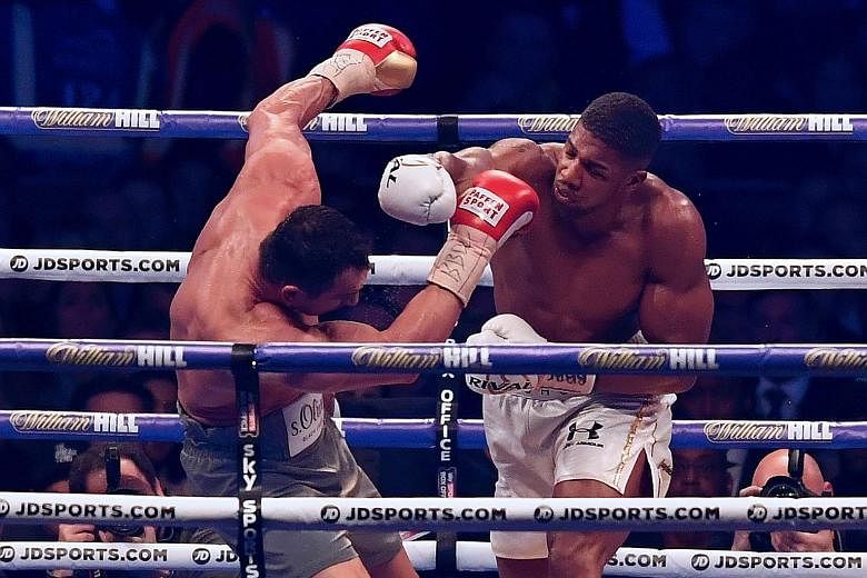 Britain's Anthony Joshua (right) connecting on a right-hand punch in his world heavyweight title fight against Wladimir Klitschko. Despite being knocked down for the first time in his professional career, Joshua managed to recover and win the bout in