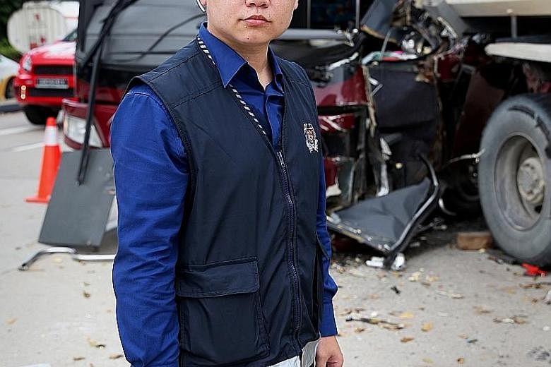 Senior Staff Sergeant Kenny Cheong at the scene of an accident on Jurong Island last Monday where a man was killed in a collision between a tipper truck and a private bus.