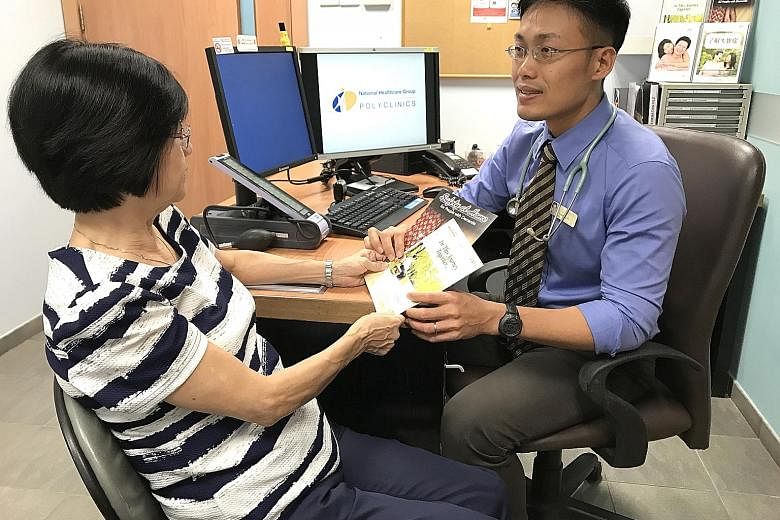 Dr Low Kang Yih, a family physician, with a patient at the Dementia Care Clinic at Ang Mo Kio Polyclinic.