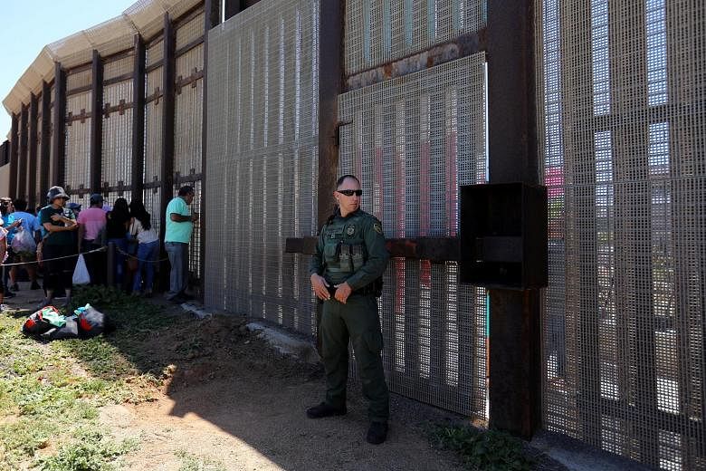 A US border patrol agent stationed along the Mexico border in San Diego last week. The White House sought funding to begin building the border wall, but this was rejected in the bipartisan deal struck by US House and Senate negotiators early yesterda