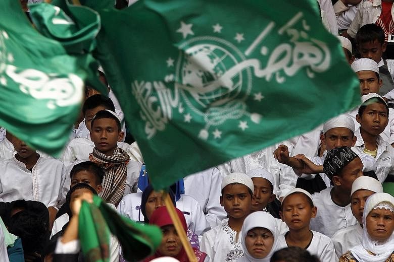 Members commemorating Nahdlatul Ulama's 85th anniversary in 2011. The world's largest mass Islamic organisation is behind a global initiative to reinterpret Islamic law dating from the Middle Ages in ways that conform to 21st-century norms.