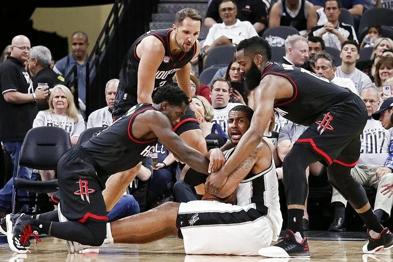 San Antonio Spurs forward LaMarcus Aldridge calling for help after being trapped by Houston Rockets' James Harden (right), Patrick Beverley (left) and Ryan Anderson. Aldridge had a poor Game One, scoring only four points.