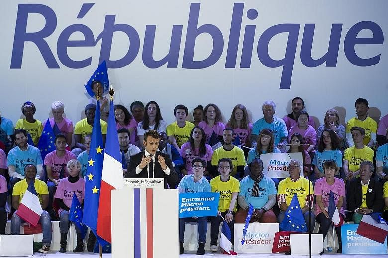French presidential candidates Emmanuel Macron and Marine Le Pen speaking at campaign events on Monday. The candidates have doubled down on their attacks against each other's economic plans for the country ahead of the second and final round of the p