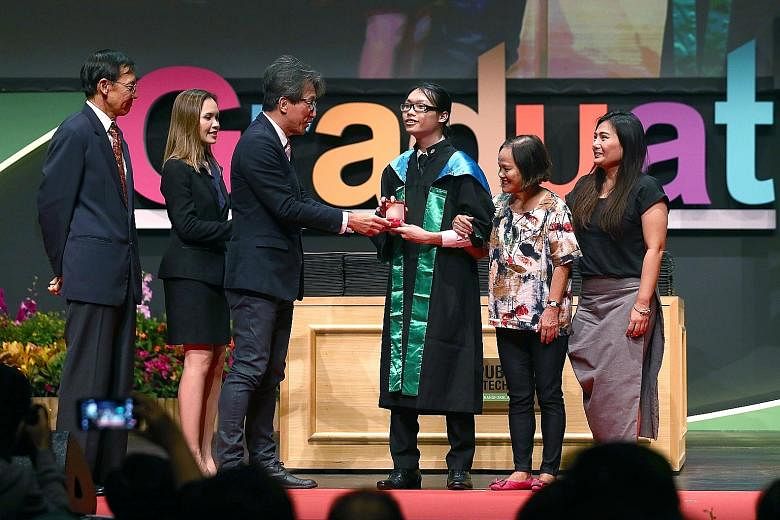 Mr Clive Chia Chun receiving the Lee Kuan Yew Award for Mathematics and Science from Manpower Minister Lim Swee Say at Republic Polytechnic. He was accompanied by his grandmother Goh Hiong Guat, 66, and mother Lilin Ng, 47. With them is Mr David Wong