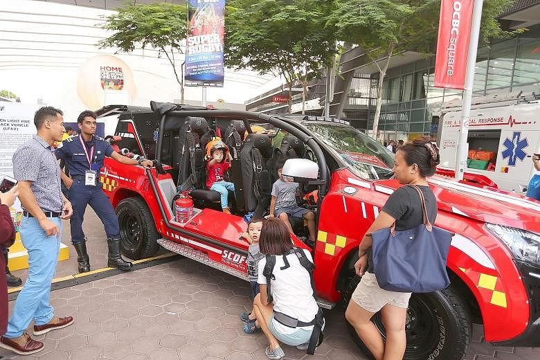 The What We Do zone at the festival showcases the capabilities of various agencies and also gives visitors a chance to become more familiar with various equipment the Home Team members use, such as a fireman's protective gear. The Singapore Civil Def