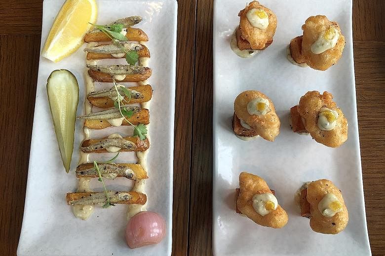 The dish in contention - Fish & Chips (far left), with whitebait, thick-cut potato, 33.1 Blond Lager pickles and tartar sauce - is in LeVeL33's Beer Dining menu and costs $13. The one on the right is the old version of the dish. It used dory fish and