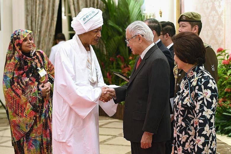 Sudan's Ambassador to Singapore Abdulrahim Alsiddig being welcomed by President Tony Tan Keng Yam and his wife Mary at the President's Annual Diplomatic Reception at the Istana yesterday. The reception, which was also attended by Prime Minister Lee H