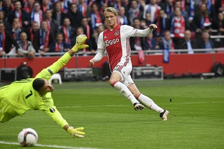 Ajax forward Kasper Dolberg scoring his team's second goal against Lyon in the Europa League semi-final first leg. Both teams combined to register 38 shots, of which 24 were on target, in an end-to-end game.