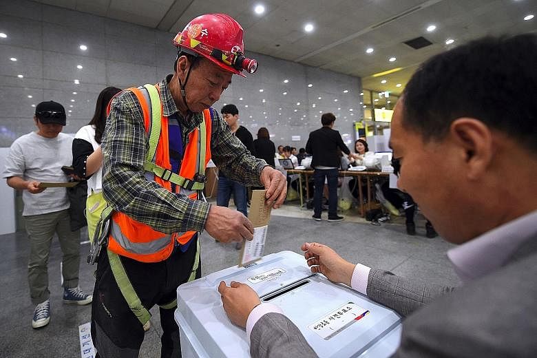 A man casting his ballot in advance at a polling station in Yongsan station in Seoul yesterday, ahead of next week's South Korean presidential election. South Koreans have up to today to cast their ballots for the May 9 presidential election, during 