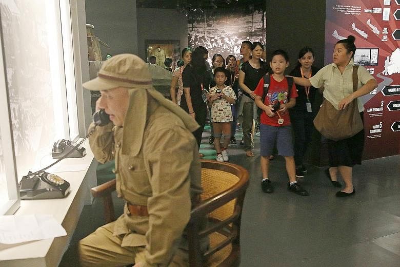 Children walking past Professor T, played by actor Julius Foo. The GosTan Back performance was designed to cater to all children, including those with special needs, at the National Museum of Singapore yesterday.
