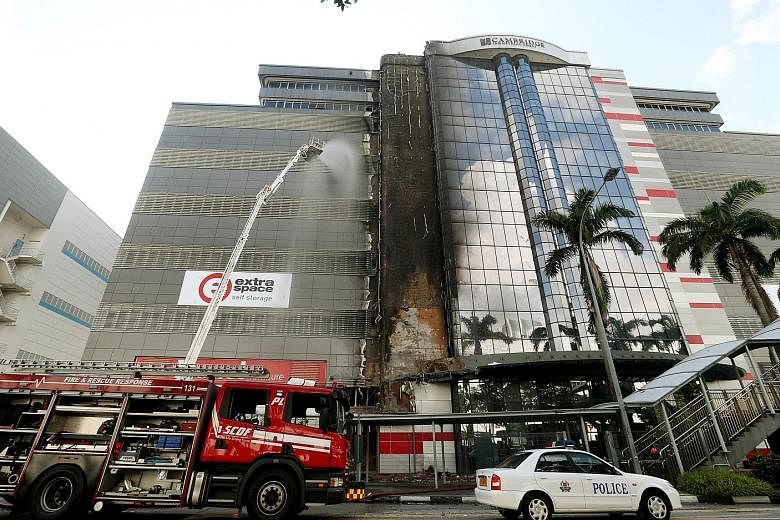 The SCDF and police were alerted to the fire at 7.38am yesterday and it was put out with three water jets within 40 minutes The fire was confined to the facade of the building at 30 Toh Guan Road. An engineer has inspected and confirmed that the buil