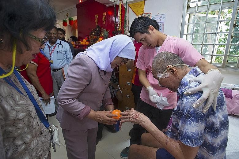 Marsiling-Yew Tee GRC MP Halimah Yacob visiting Mr Ng Teng Sun, a beneficiary of the Sunlove Community Care Centre. The centre provides free immediate healthcare services to elderly residents living nearby.