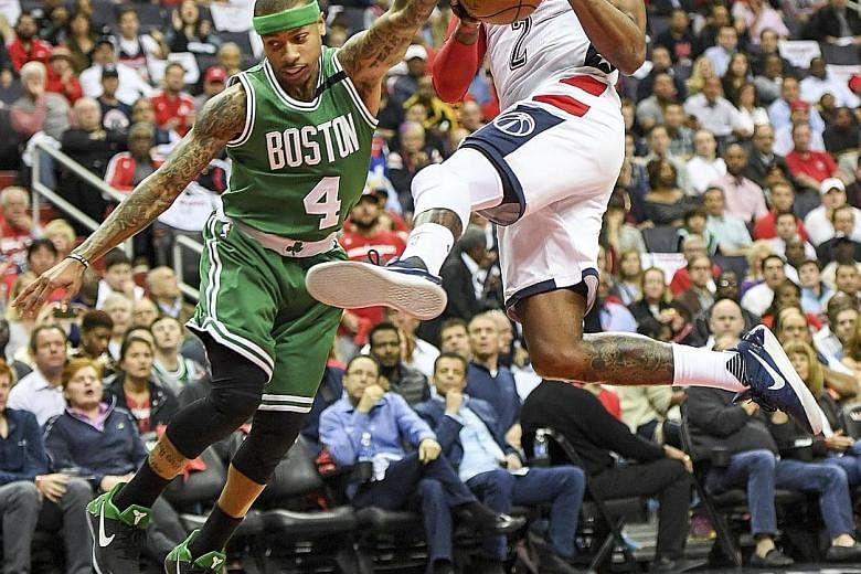 Wizards forward Kelly Oubre Jr (above, left) is held back by referee Monty McCutchen after shoving Celtics centre Kelly Olynyk during the second quarter of their Eastern Conference semi-final clash.