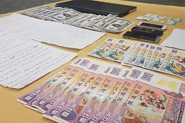 Threatening letters on the closure of the Sungei Road flea market and hell notes were sent to four Cabinet ministers and a newspaper reporter. Mobile phones and a laptop were also seized by police.