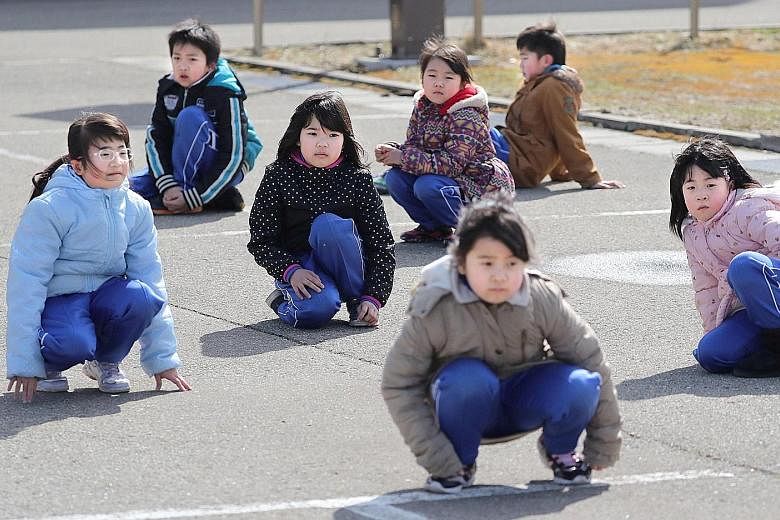 Elementary school pupils participating in Japan's first missile evacuation drill in Oga, Akita prefecture, in March. Pyongyang had said a ballistic missile test was a successful dry run for a strike on US bases in Japan.