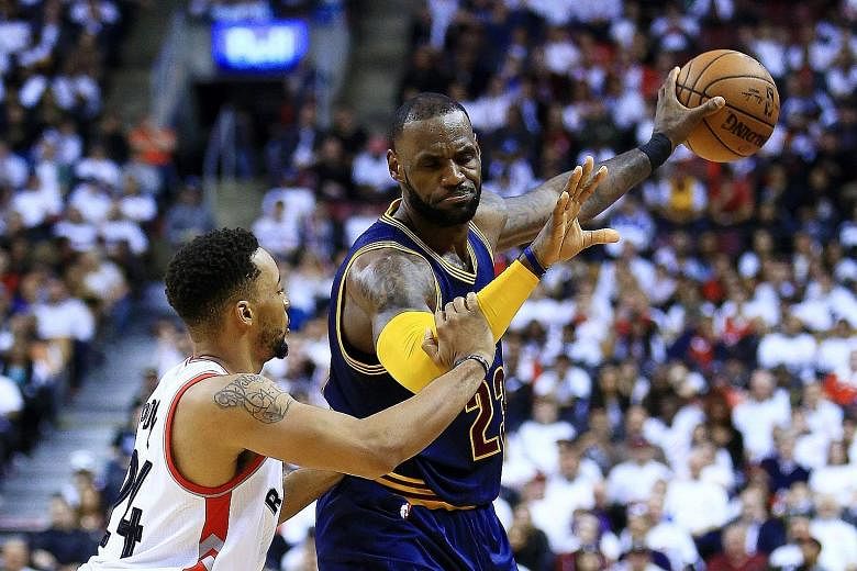 Cleveland's LeBron James shielding the ball away from Toronto's Norman Powell in Game 3 of the Eastern Conference semi-finals. The Cavaliers won 115-94 to take a 3-0 lead.