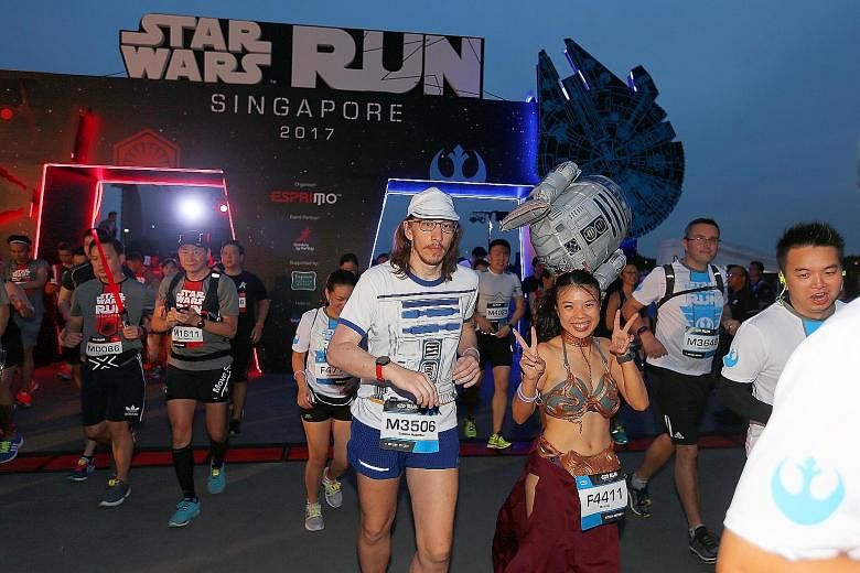 Runners decked out in an R2-D2 T-shirt and Princess Leia costume were among 15,000 who took part in the Star Wars Run at Marina Bay yesterday. The run was part of the Star Wars: May the Fourth Be With You Festival to celebrate the beloved movie franc