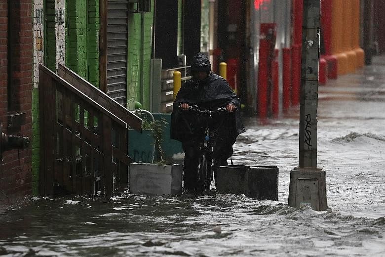 A flooded street in Brooklyn, New York, on Friday. Mr Donald Trump had promised to cancel the Paris Agreement on climate change during his presidential campaign. He has since said he will decide on the deal before the G7 meeting later this month.