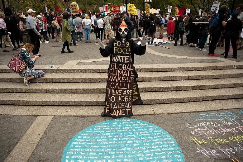 A protester warning against the dangers of climate change during a May Day rally in Union Square, New York, on May 1. The 21st century has seen 16 of the 17 hottest years since records began in 1880. Arctic summer sea ice also shrank to 4.14 million 