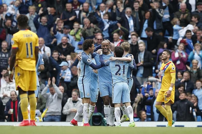 Manchester City skipper Vincent Kompany (centre) celebrates scoring their second goal with Leroy Sane (left), David Silva and Kevin de Bruyne.