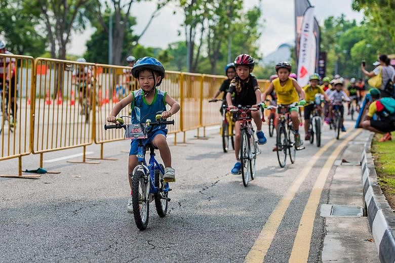 Seven-year-old Joel Liaw leading the way in yesterday's 5km introductory race in the Tri-Factor Bike & CycleRun Challenge. The nine-category event drew 1,285 participants to Nicoll Highway. David Strooper won the men's veterans' 49km bike race in 1hr