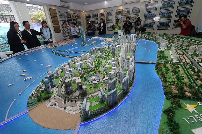 China's Ambassador to Malaysia Huang Huikang (second from left) checking out a model of the Melaka Gateway project with KAJ Developments CEO Michelle Ong (left) in March. Industry players and government officials are now doubtful about the project ta