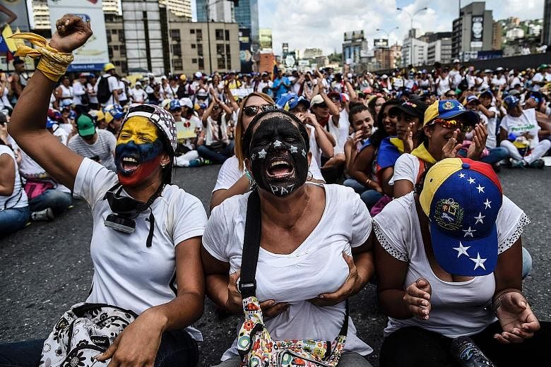 Venezuelan opposition activists taking part in a march in Caracas on Saturday aimed at keeping pressure on President Nicolas Maduro, whose authority is being increasingly challenged by protests and deadly unrest. Some women flashed their breasts in a