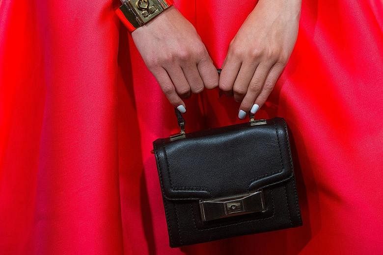 A Kate Spade handbag. Coach says the complementary nature of the businesses should bring US$50 million in cost savings in three years after the deal closes. The idea is to improve scale and inventory management, as well as streamline Kate Spade's sup
