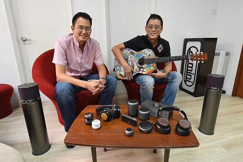 Co-founders of XMI and brothers Reuben (left) and Ryan Lee, who is the chief executive, with some of the company's audio products. Despite financial mismanagement, wireless technology disruption and lost margins due to e-commerce, XMI - after a fund-