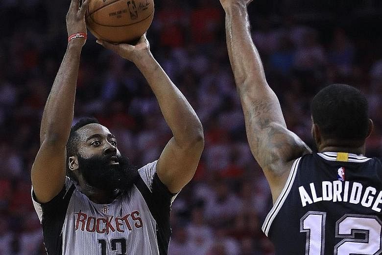 James Harden of the Houston Rockets shooting against LaMarcus Aldridge of the San Antonio Spurs. Harden scored 28 points as his team led from start to finish, with six of his team-mates also getting into double figures in the 125-104 win that tied th