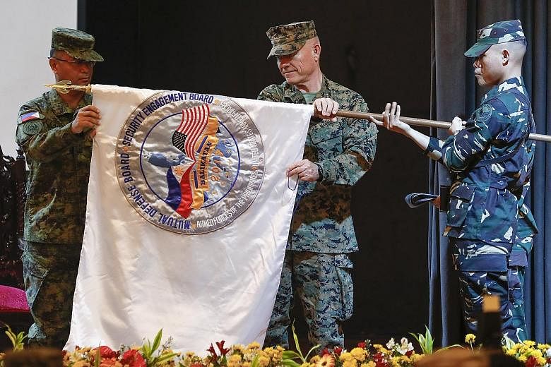 Philippine Lieutenant- General Oscar Lactao (left) and US Marines Lieutenant- General Lawrence Nicholson at the opening ceremony of the annual Balikatan exercise in Quezon City, east of Manila, yesterday.
