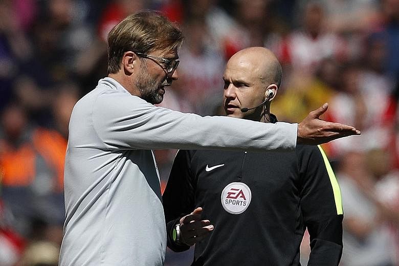 Liverpool manager Jurgen Klopp speaking to fourth official Anthony Taylor during the Premier League match against Southampton at Anfield which ended 0-0.