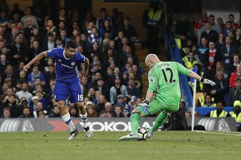 Chelsea striker Diego Costa scoring his team's first goal against Middlesbrough goalkeeper Brad Guzan on Monday. The Premier League match, which ended 3-0 for the Blues, also condemned Boro to relegation.
