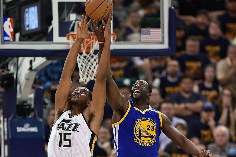 The Utah Jazz's Derrick Favors (left) tussles for the ball with Golden State Warriors' Draymond Green in their Game Four Western Conference semi-final series clash. Green had a triple-double with 17 points, 11 assists and 10 rebounds as the Warriors 