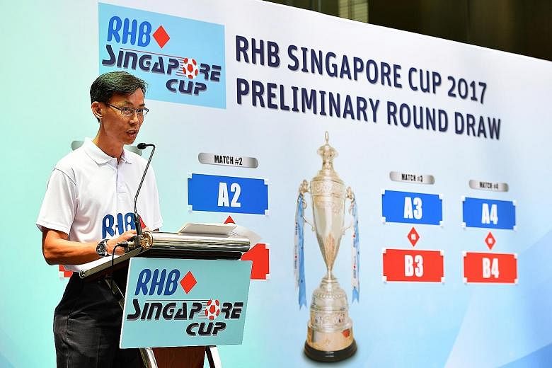 New FAS council member Michael Foo applauding RHB for their continuing support of local football at the Singapore Cup draw yesterday.