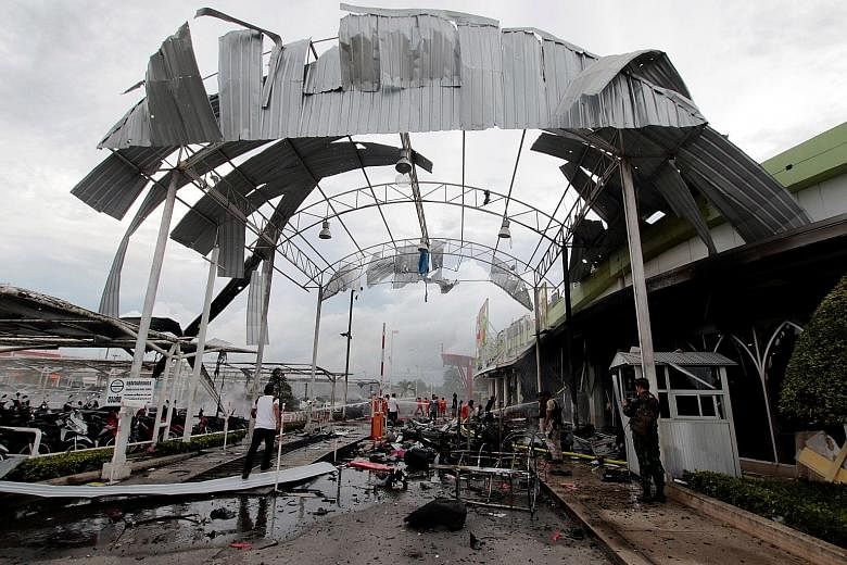The front of the Big C supermarket in Pattani was destroyed by the blasts yesterday. The authorities suspect that Muslim militants were behind the attack. Police said the first device was packed inside a motorcycle in a carpark, while the second was 