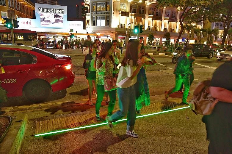 The Victoria Street crossing outside Bugis Junction is one of two locations to have LED strips. The junction of Buyong Road and Orchard Road, near the Istana, is the other location. The LTA is trying out the road-crossing feature for six months.
