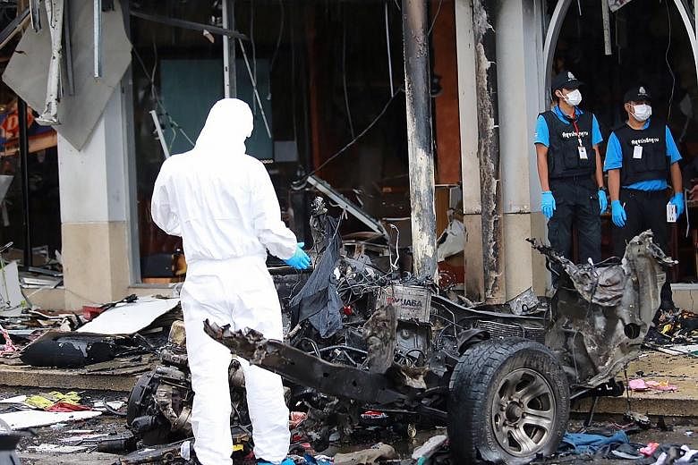 A Thai forensic police officer inspecting a vehicle damaged by the car bomb on Tuesday.