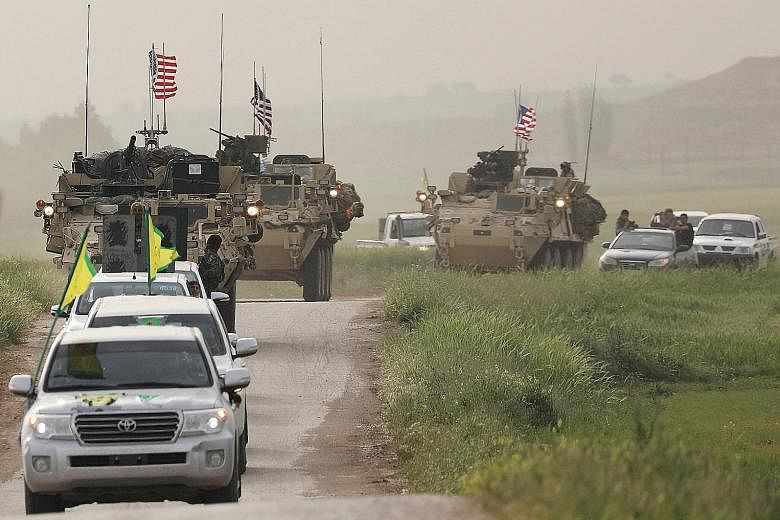Kurdish forces in Syria heading a convoy of US military vehicles. The US sees the militia as a valuable partner in the fight against ISIS.