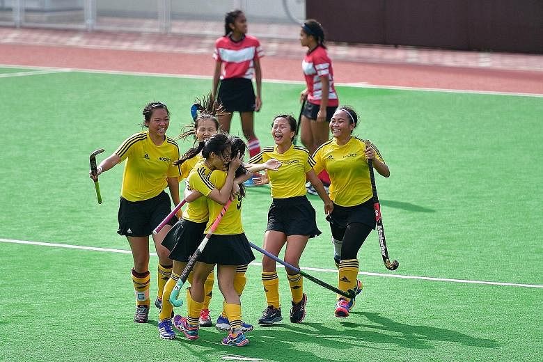 Klara Chong (third from left) embraces a team-mate in jubilation after scoring the golden goal to help Victoria Junior College claim their 15th straight A Division girls' hockey championship. Below: Raffles Institution's match winner Ramalingam Gouth