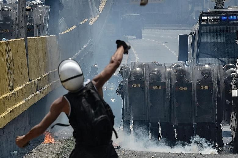 Venezuelan opposition activists clashed with riot police during a protest in Caracas against President Nicolas Maduro on Wednesday - the latest in a series of violent demonstrations.