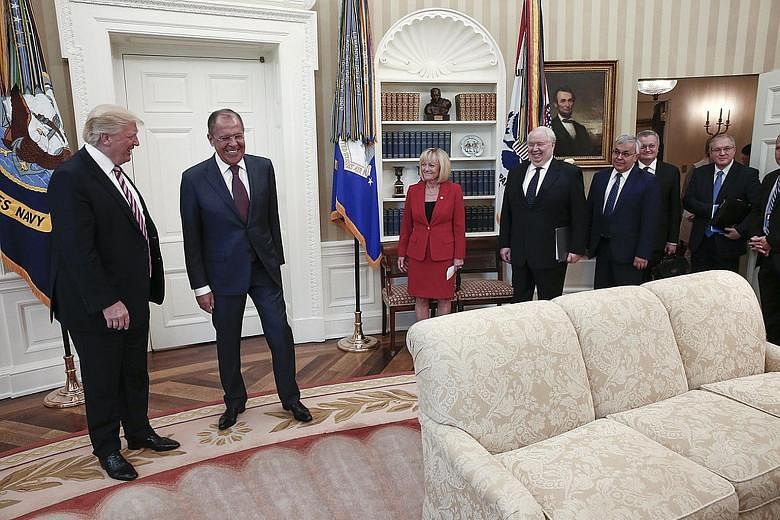 A handout photo made available by the Russian Foreign Ministry on Wednesday shows US President Donald Trump (far left) and Russian Foreign Minister Sergei Lavrov (second from left) meeting in the Oval Office. White House officials denied US reporters